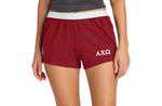 Person wearing red shorts with a logo on a white background