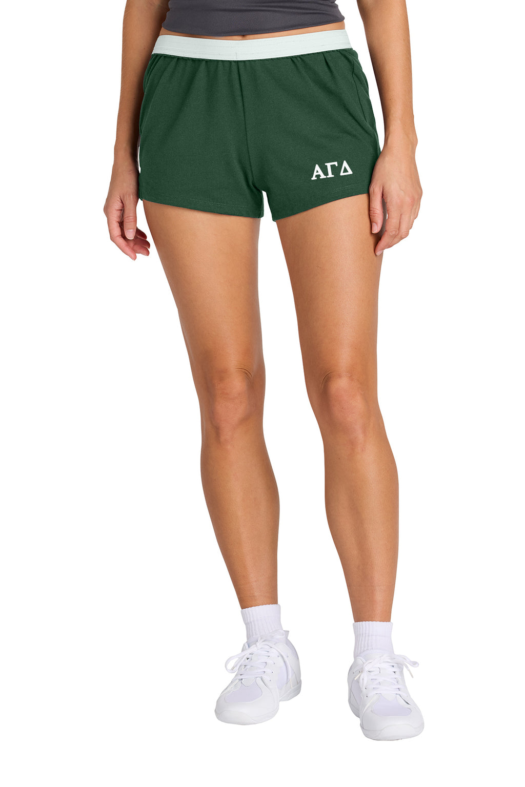 Person wearing maroon shorts with a logo on a white background