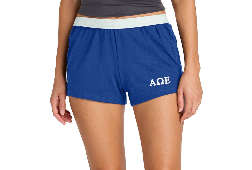 Person wearing blue shorts with a logo on a white background