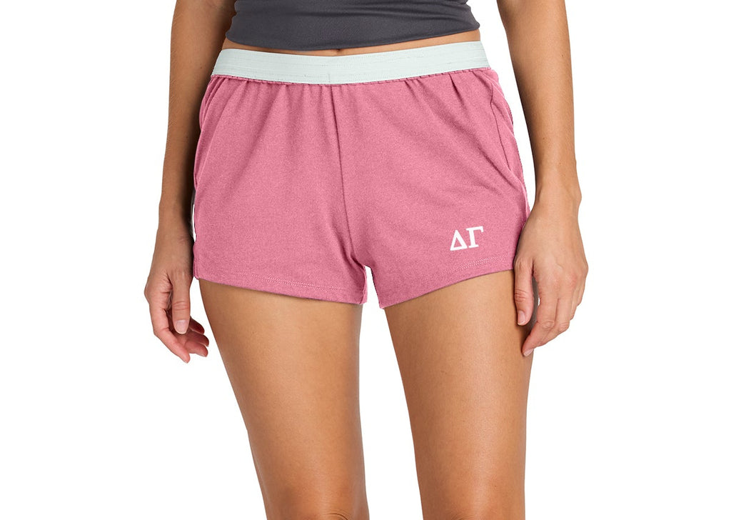Person wearing pink shorts with a logo on a white background