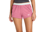 Person wearing pink shorts with a logo on a white background