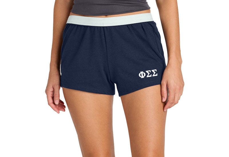 Person wearing navy shorts with a logo on a white background