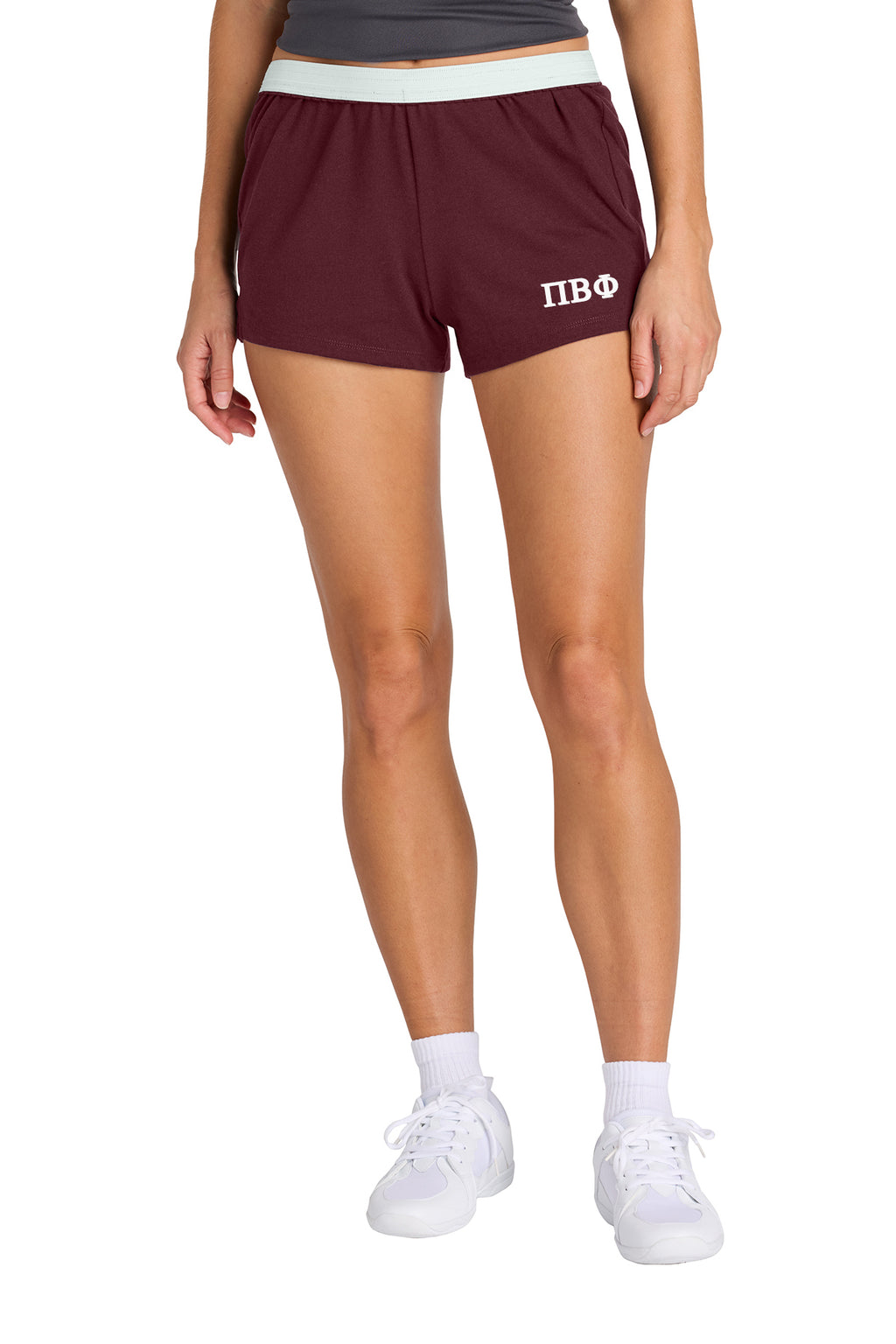Person wearing navy shorts with a logo on a white background